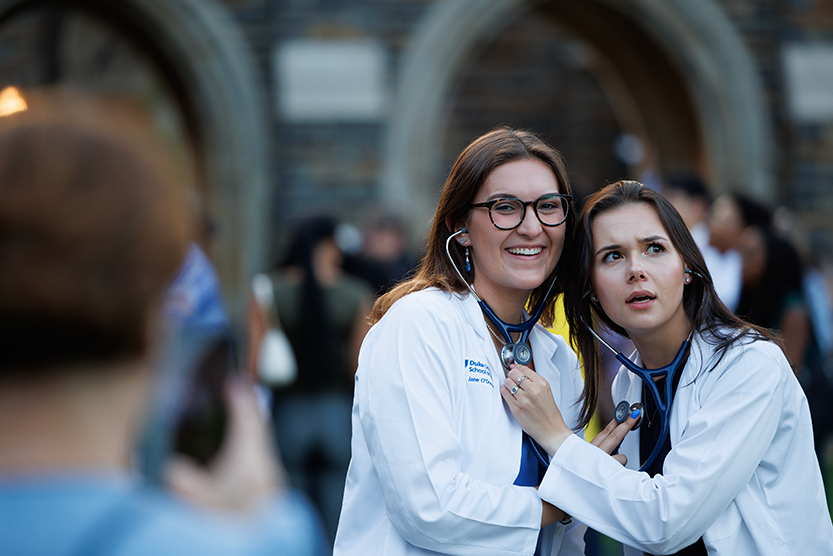 two students listening to each other's hearts with their new stethoscopes