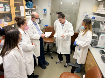 Bart Haynes meets with his lab team.