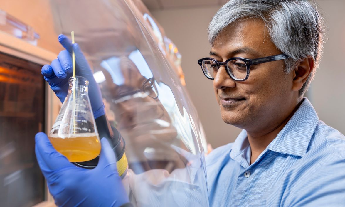 Neil Surana examining liquid in a test tube 