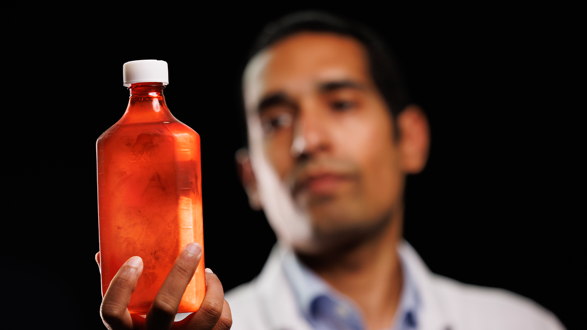 Dr. Selvaraj holding a bottle of keytones