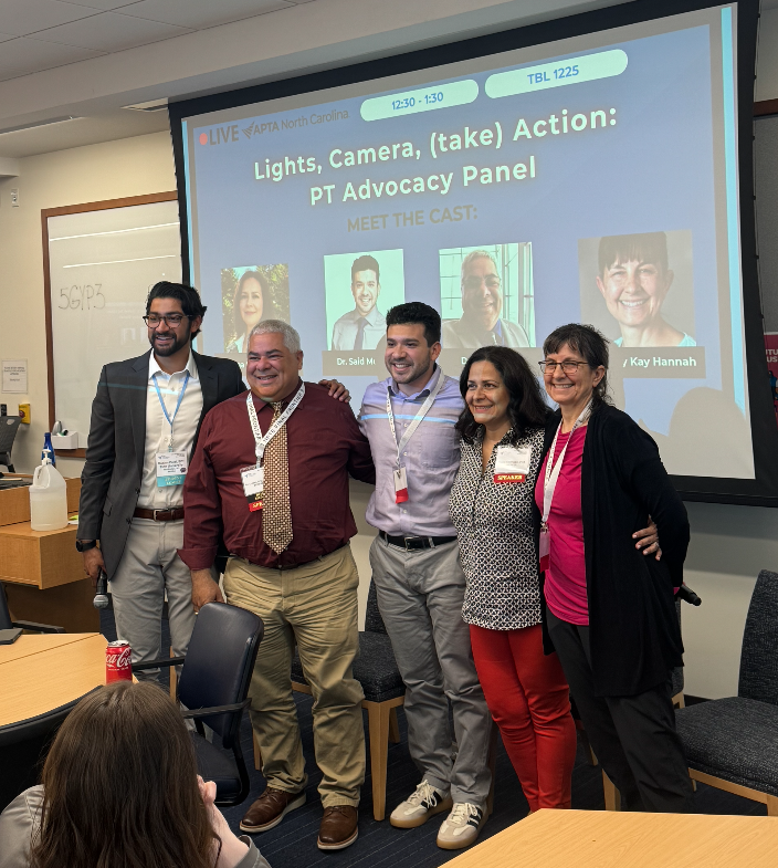DPT student group posed near screen
