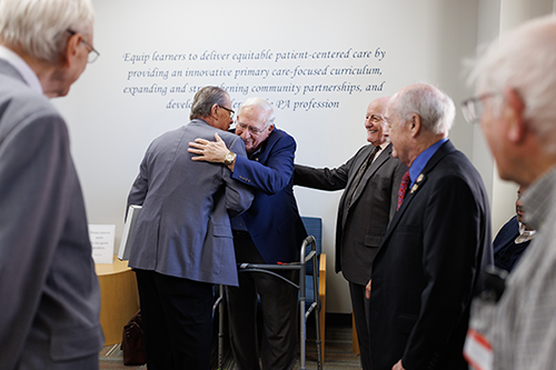 Ken Ferrell hugging one of the Duke PA Pioneers