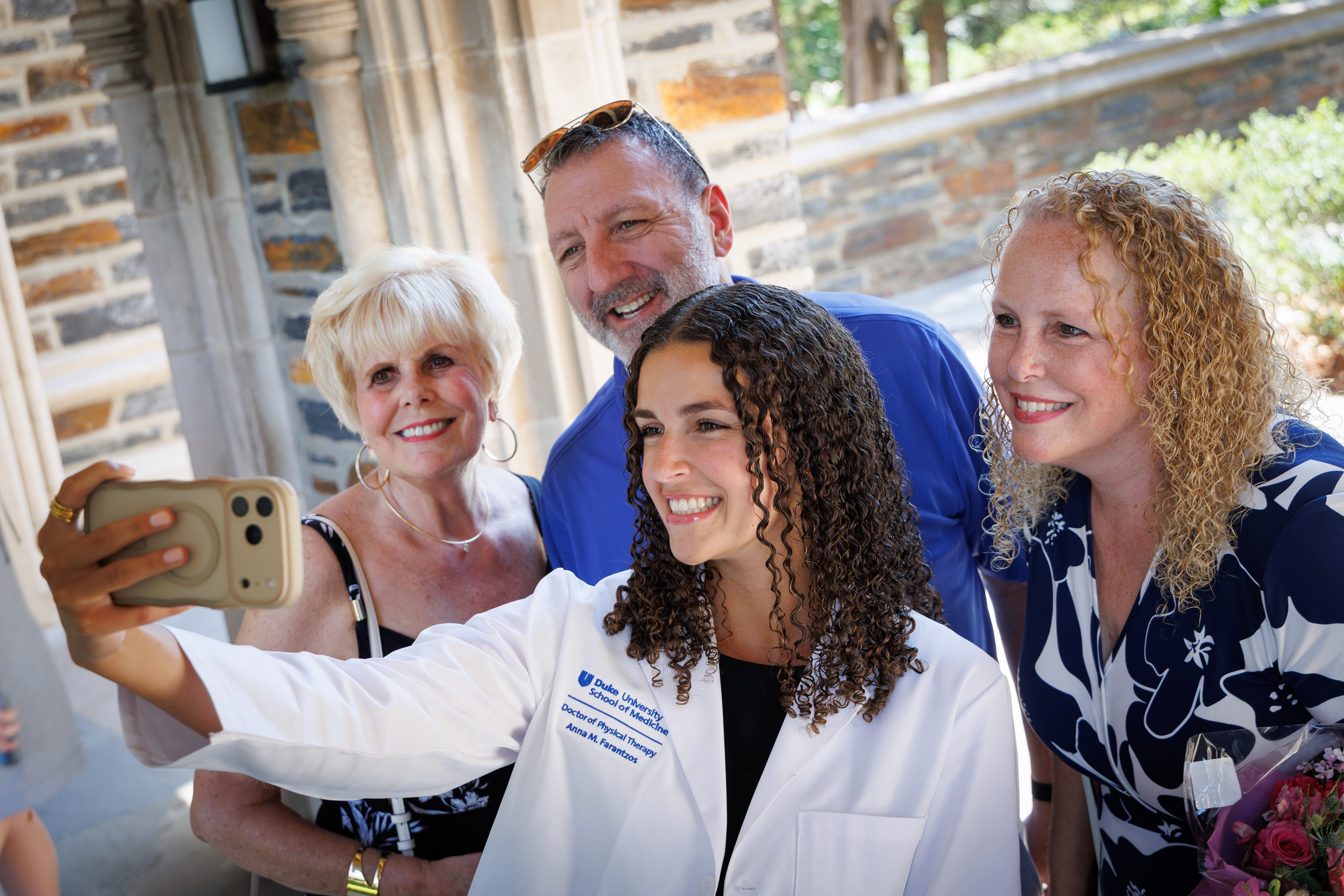 student takes selfie with family outside of Duke Chapel