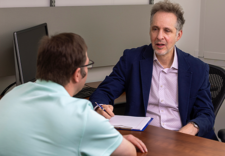 Dr. Elbogen consulting with a patient. 