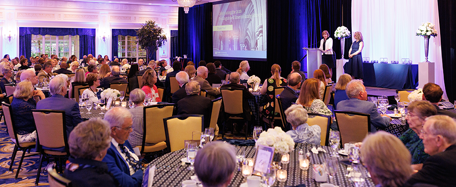 Emeriti dinner celebration. Dean Klotman and Vice Dean for fauclty Dr. Becker standing on a podium presenting awards. 