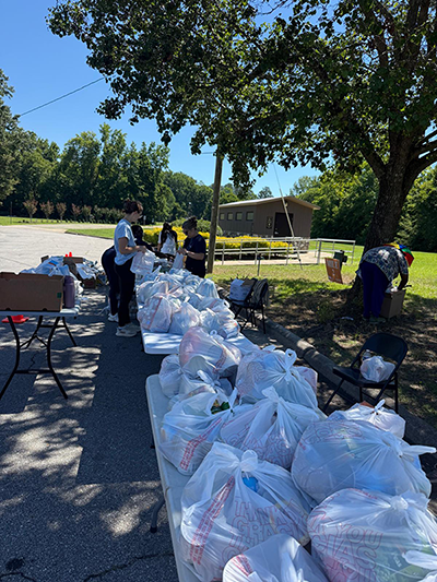 Students organizing bags of food outside for food bank.