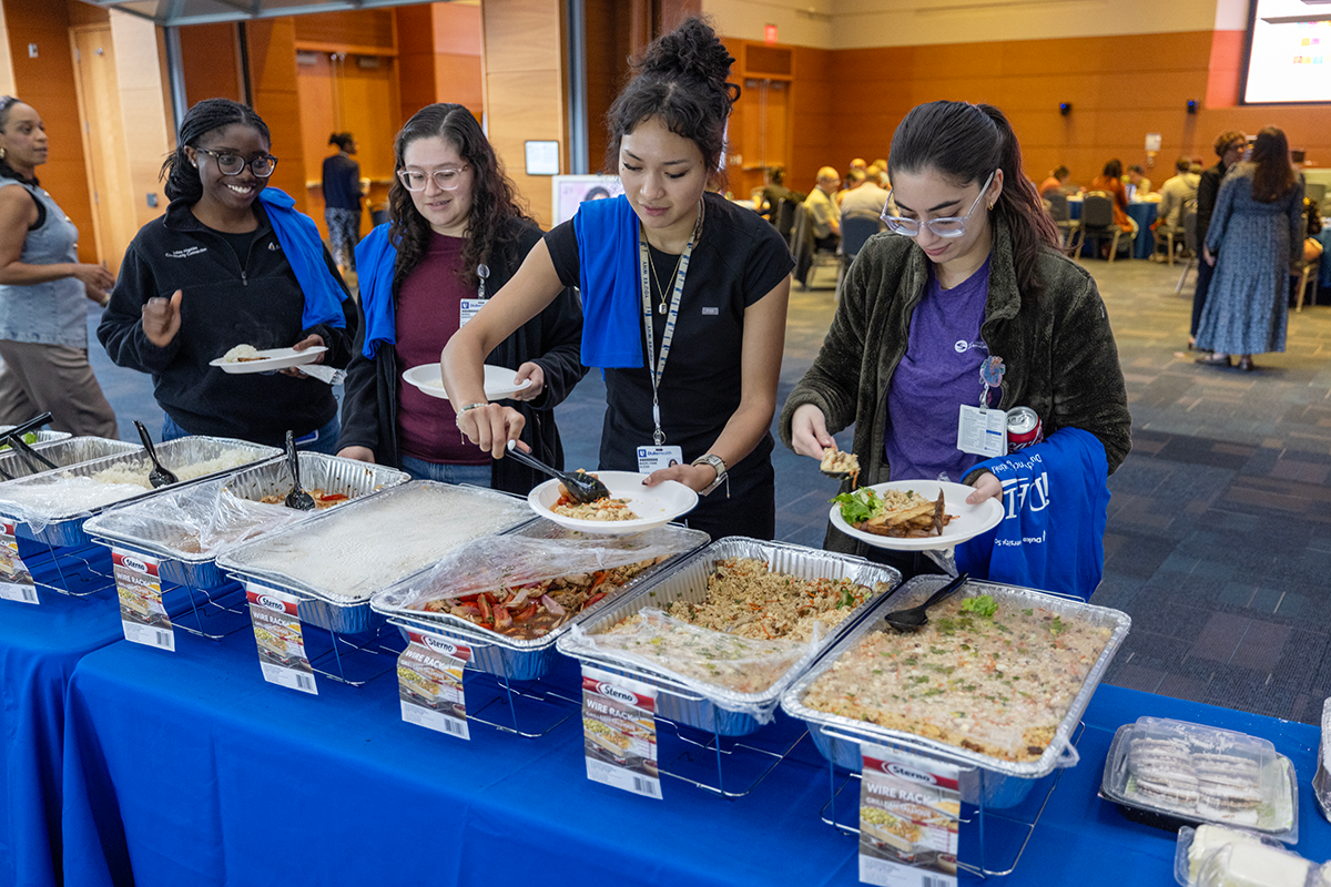 participants serving themselves food from a buffet