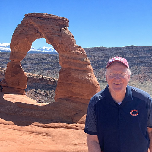 duke pa alumni, thomas cureton, posing for photo in front of mountains