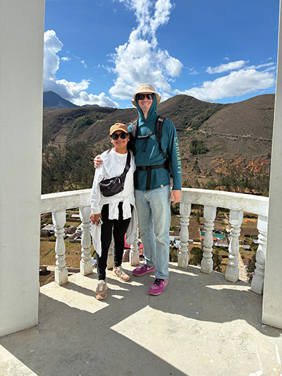 Couple standing together in front of mountains