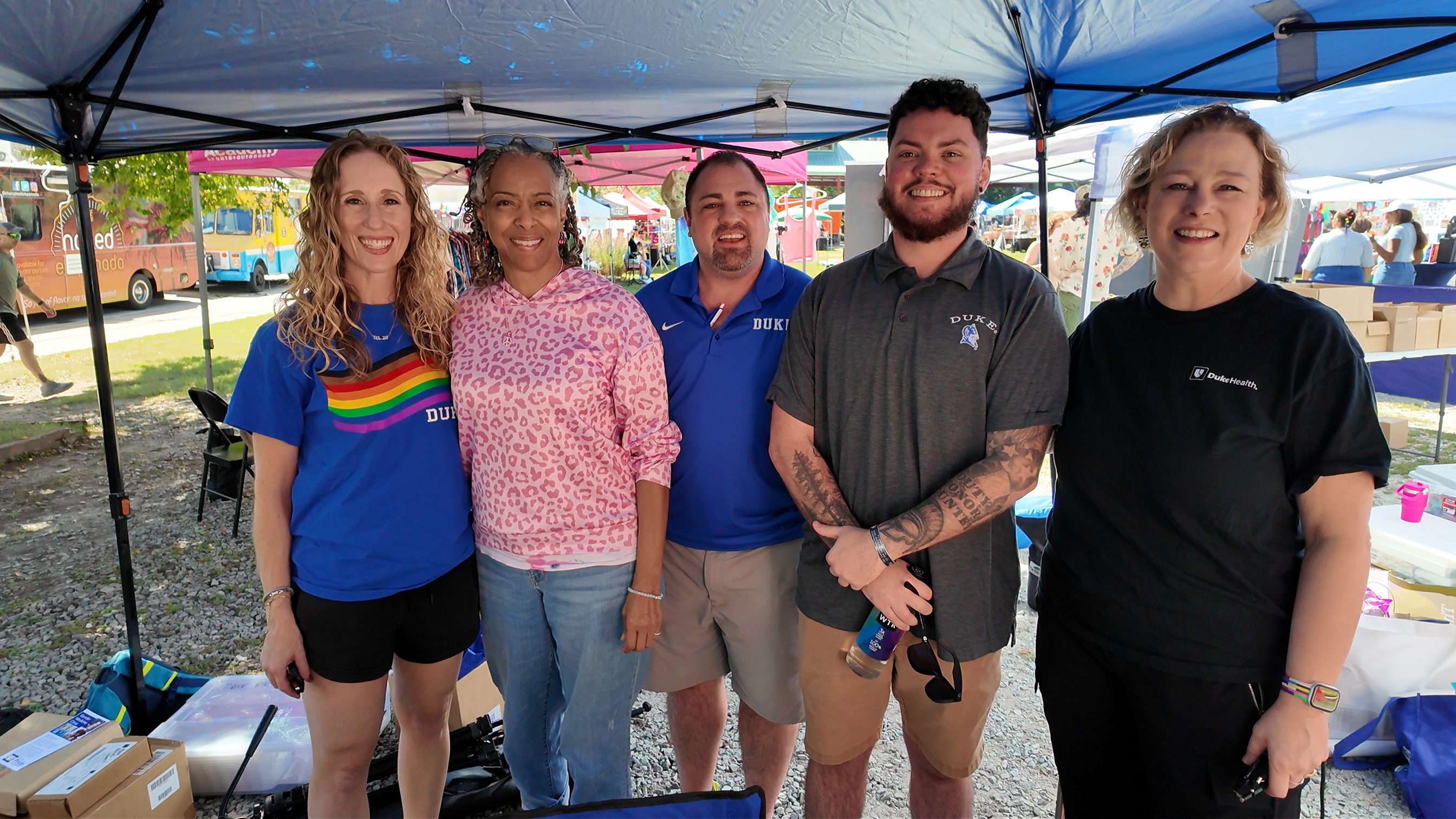 Group stands under tent at Durham Pride 2026