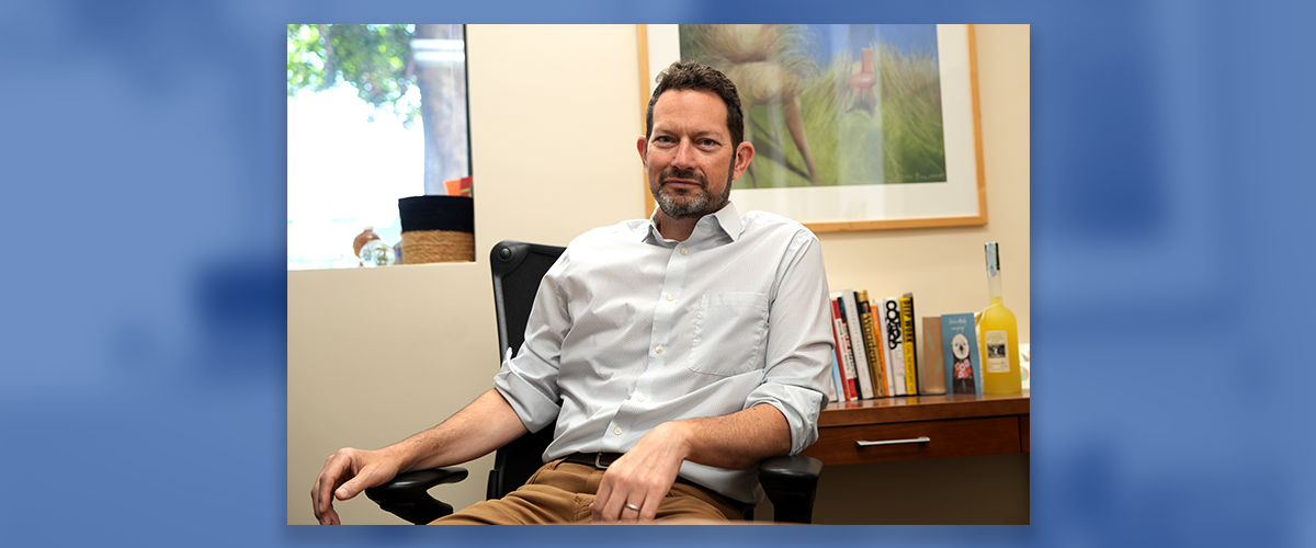 Image: Luftig sitting at his desk in his office
