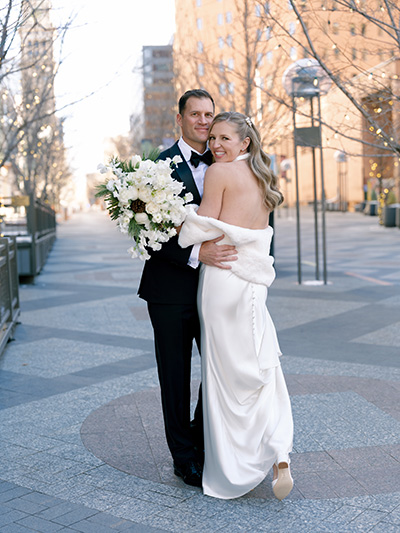 a couple inwedding attire taking a photo