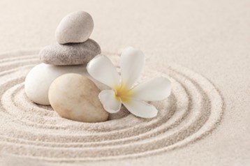Stacked rocks on sand - Koru Mindfulness