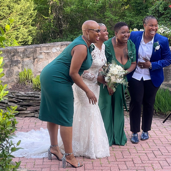 teoma and her family laughing at a wedding