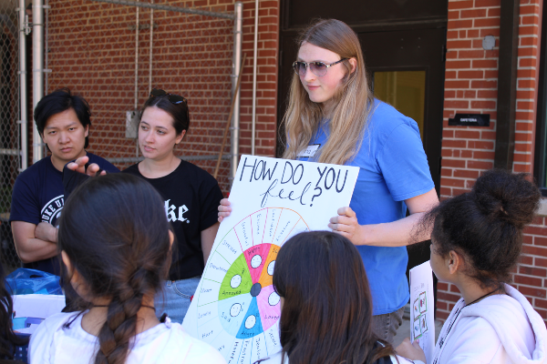 Duke students working with Burton students to discuss feelings