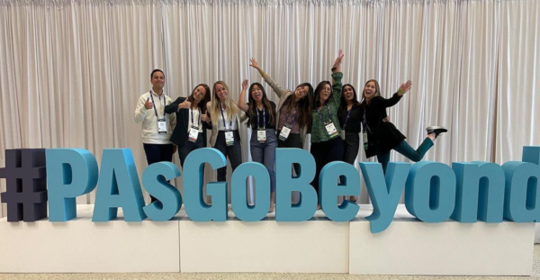 Students standing on top of large #PAsGoBeyond sign