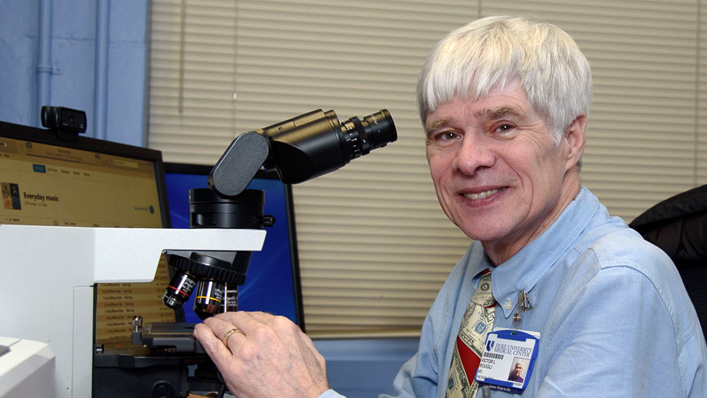 Victor Louis Roggli with a microscope