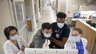 Duke Cardiology fellow rounds with other team members in the Cardiac Intensive Care Unit at the Duke Medical Pavilion