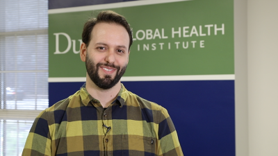 main standing infront of sign that says Duke Global Health Institute