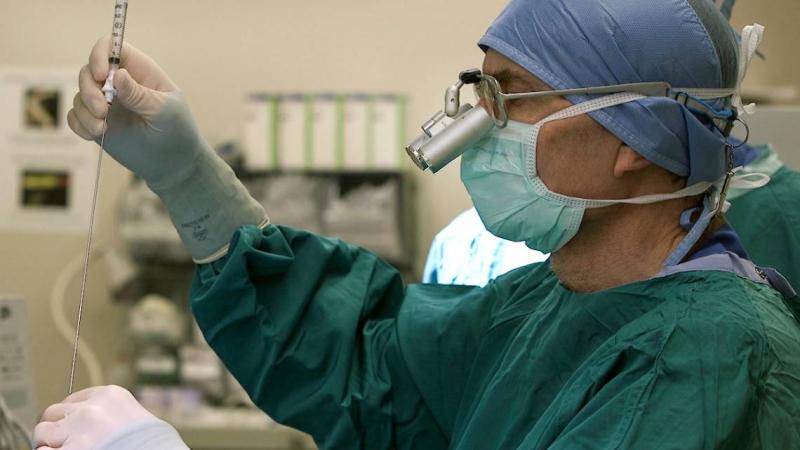 Surgeon performing a glioblastoma biopsy
