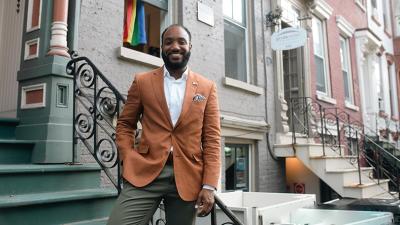 Man stands on steps outside NY apartment building