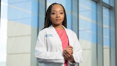 female medical student in white coat