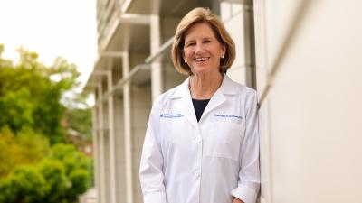 woman in white coat standing outside