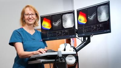 woman physician standing with imaging machine