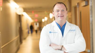 man in white coat in hallway