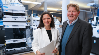 Sarah Armstrong and Christopher Newgard in a lab