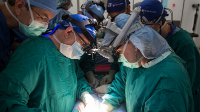 Debra Sudan and other surgeons performing a transplant surgery. 