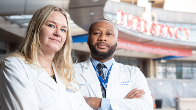 Krista Haines, DO and Anthony Eze, MD in front of the Emergency entrance to the ER at Duke