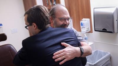 patient gratefully embracing his physician
