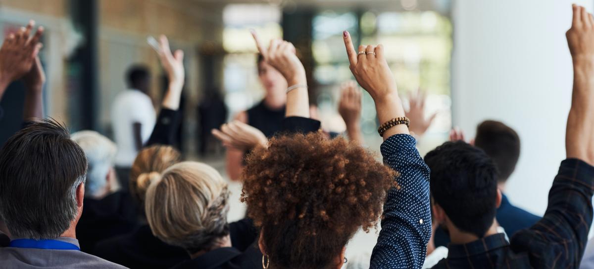 people asking questions with hands raised