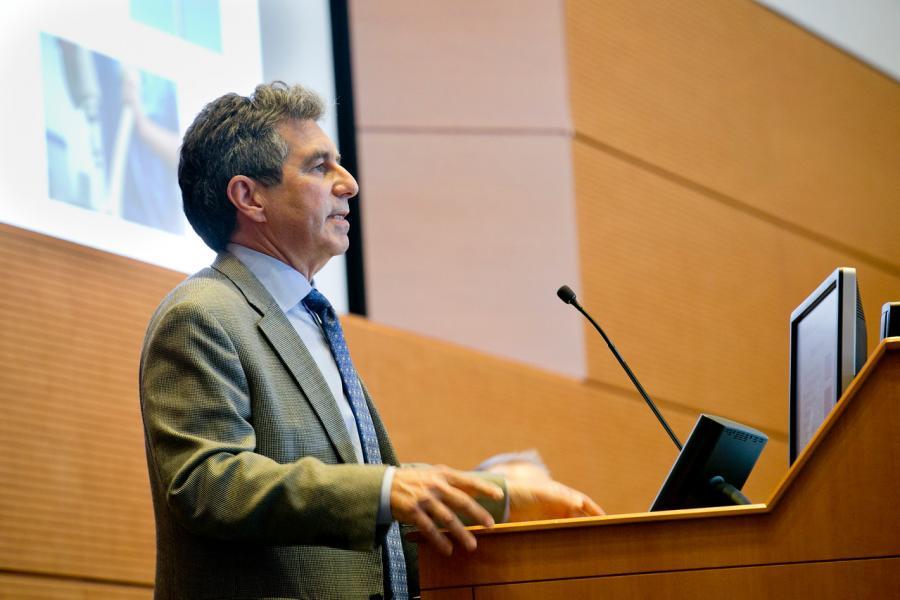 man standing at podium speaking