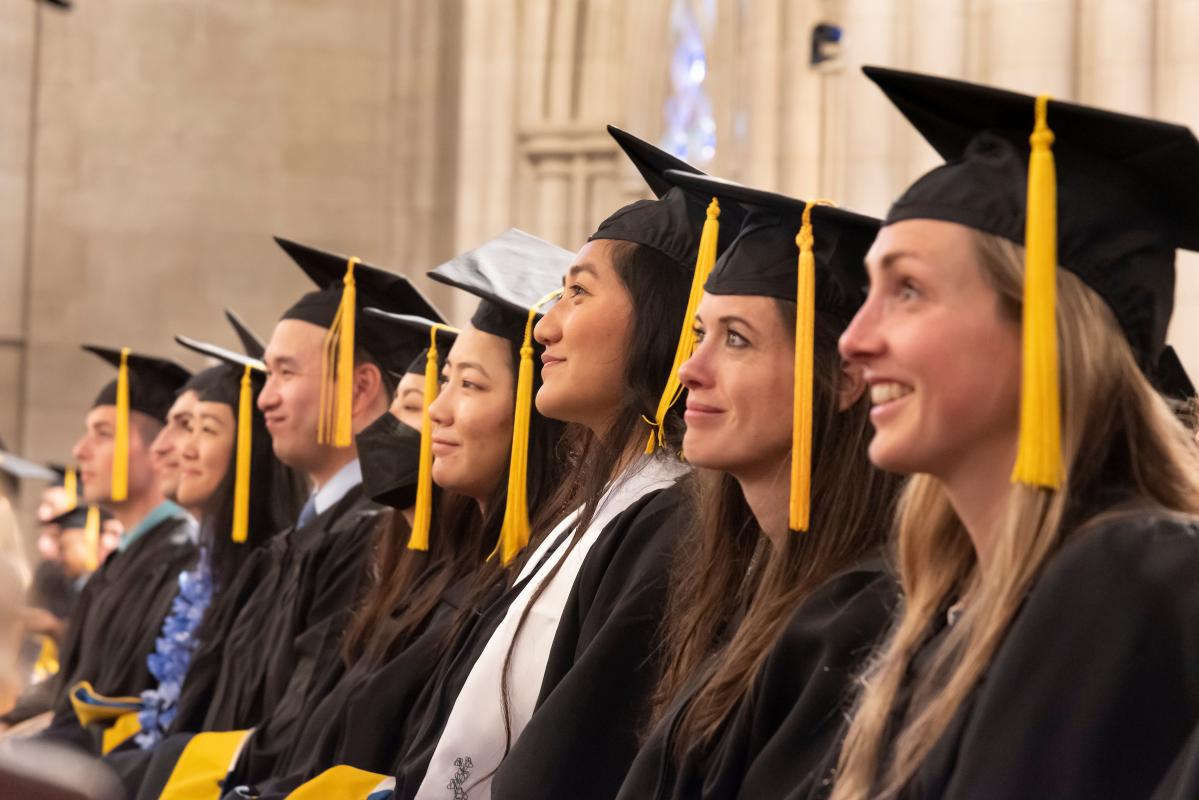students at graduation in caps and gowns