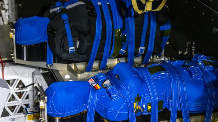 Manikins strapped into a vessel that will travel to the moon. 