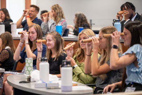 A group of students viewing teleidoscopes