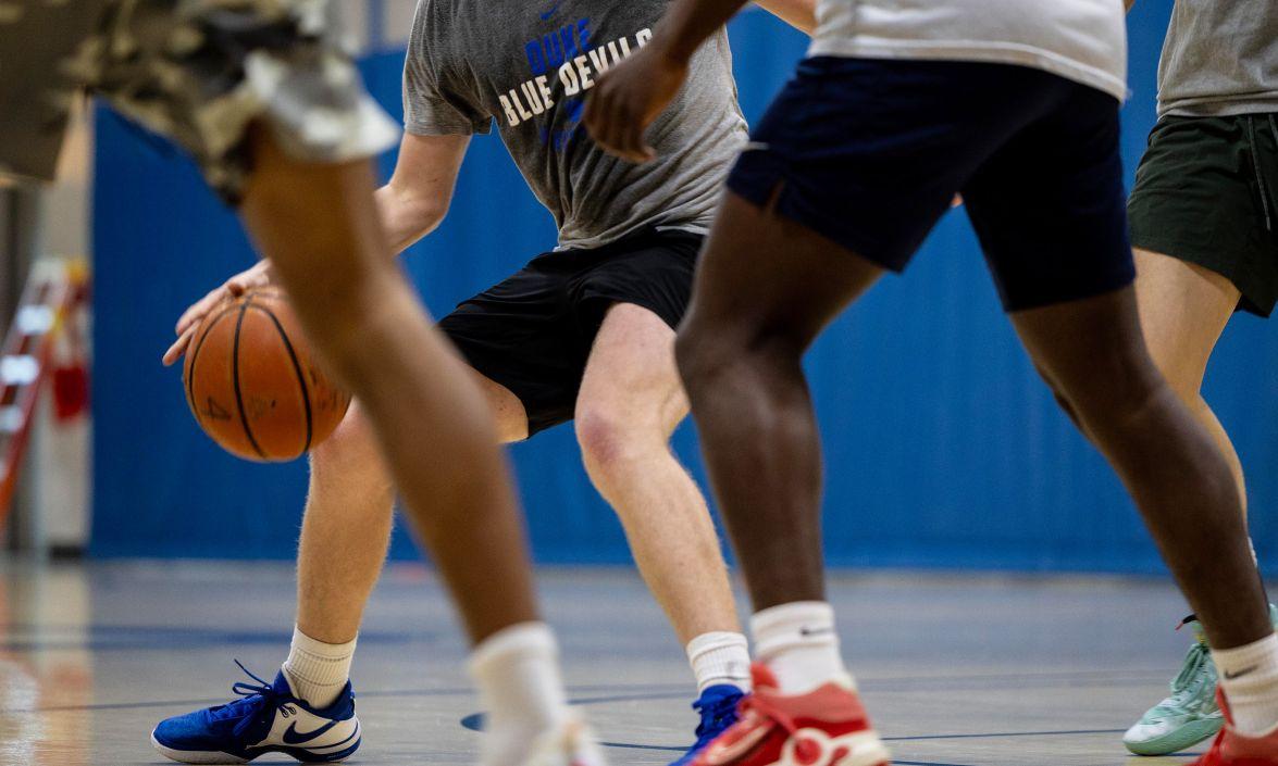 view of the legs of various basketball players with the ball in play. 
