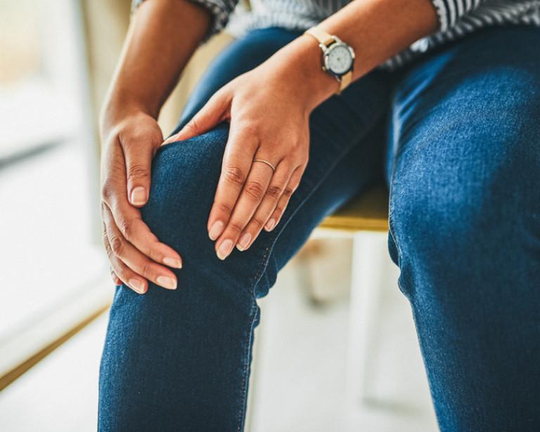 hands holding the sides of a knee