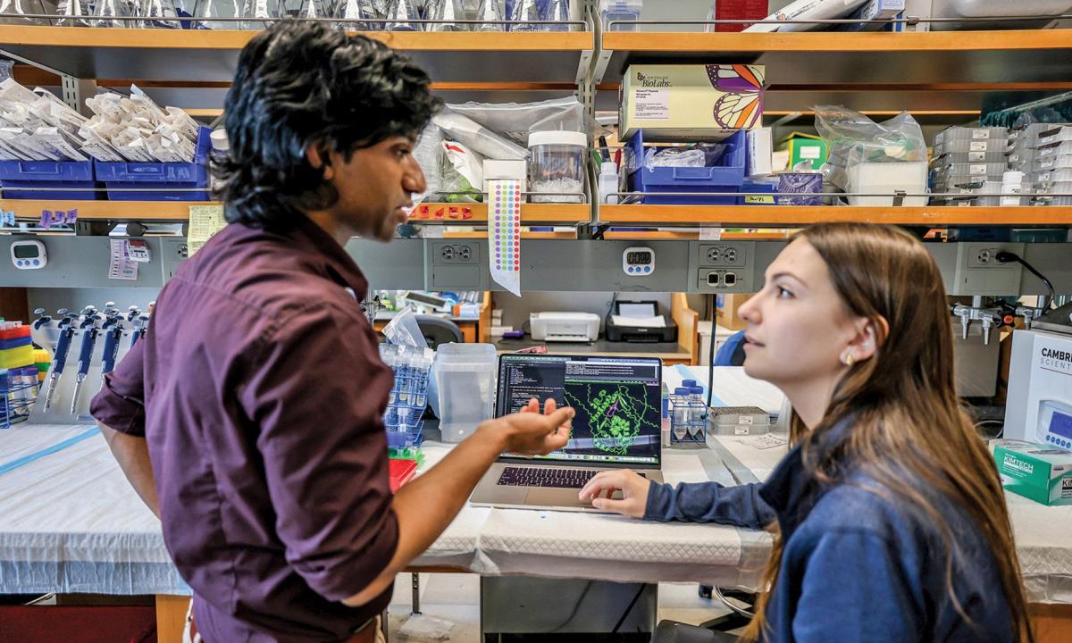 Professor talking to student at a lab bench