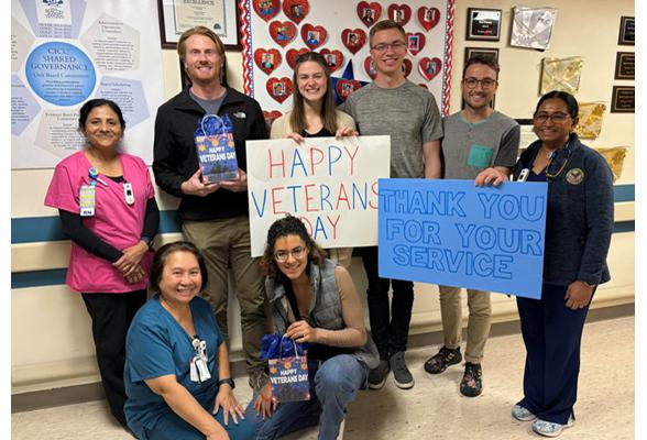 PA students holding signs that say Happy Veterans Day and Thank You For Your Service