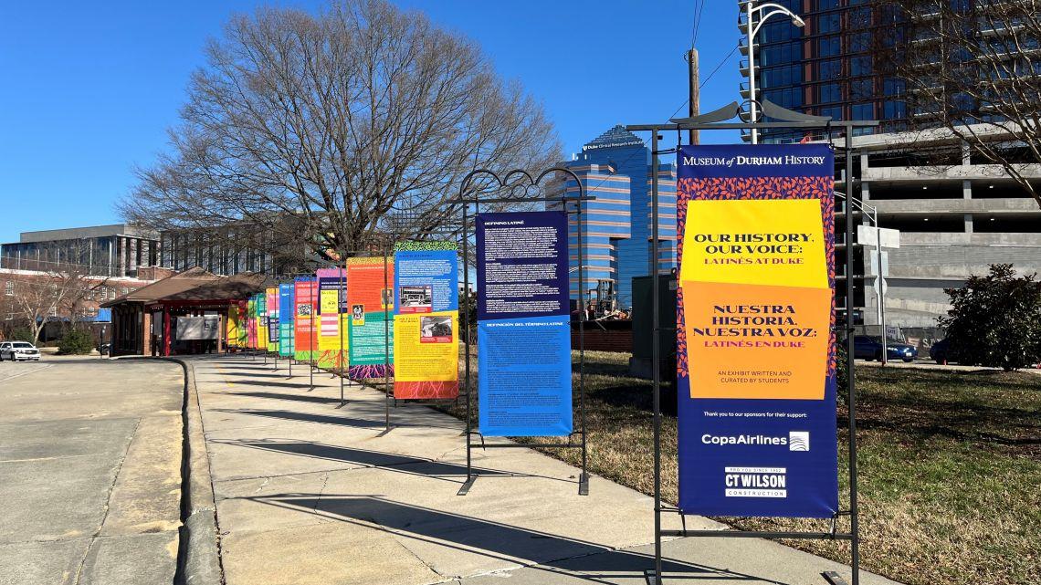 colorful panels lined up on a sidewalk outside the Museum of Durham History