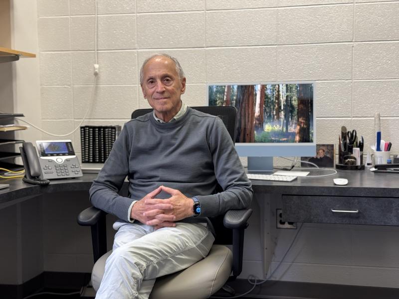 Portrait of Dr. Michael Hershfield sitting in his office