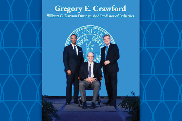 Gregory Crawford receiving award