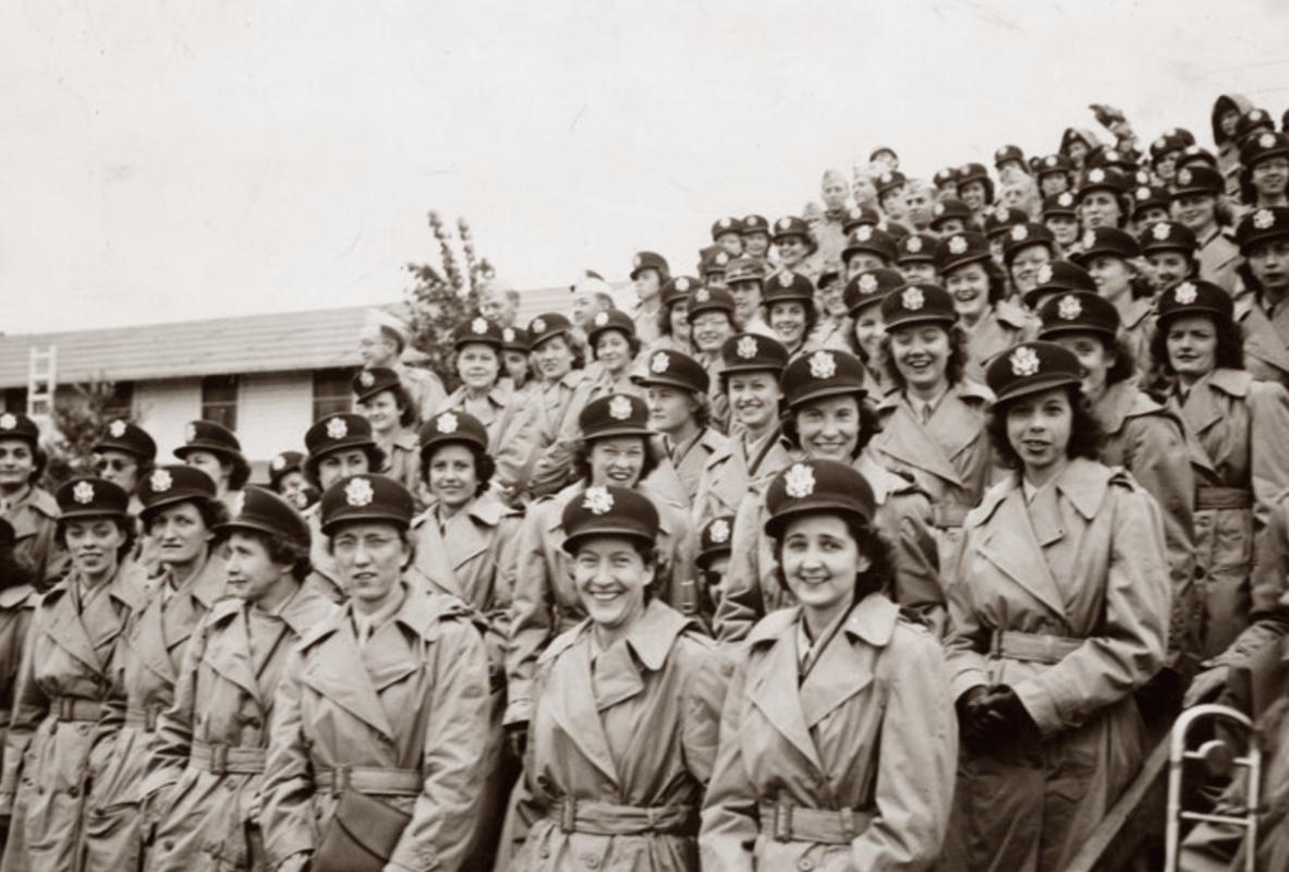 Uniformed nurses and servicemen of the 65th General Hospital awaiting embarkation for overseas duties. 