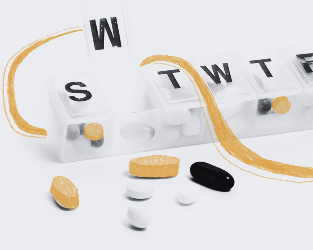 A pill container and several types of pills and capsules