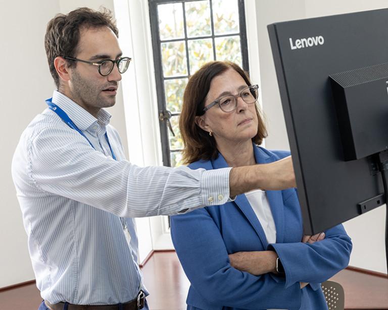 Two researchers look at a computer monitor