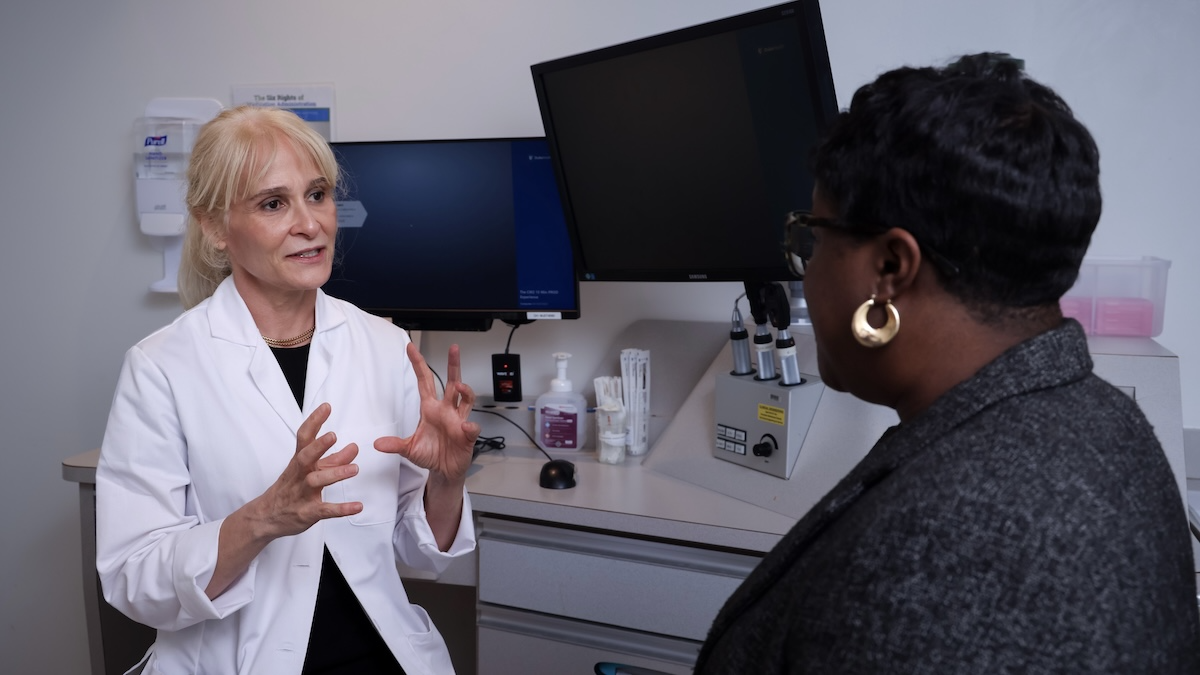 Esen Akpek, MD, speaks with a patient.