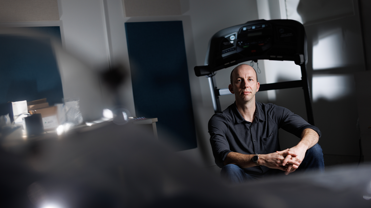 Herman Pontzer sitting on a treadmill in his lab